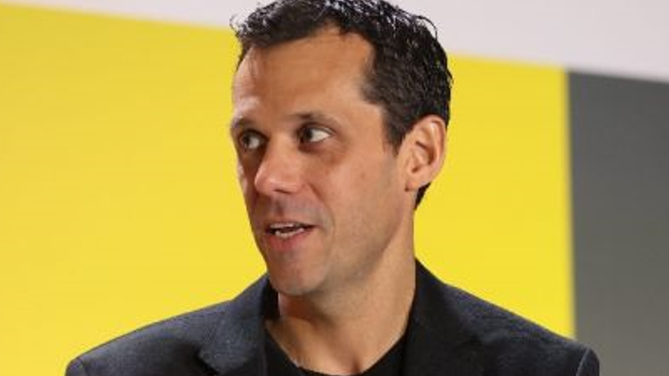 A man against a yellow background
