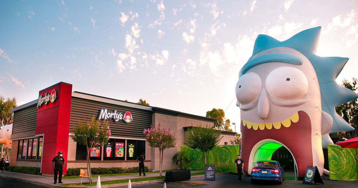 a mortys restaurant (formerly wendys) with an inflatable rick tunnel mouth cars can drive through