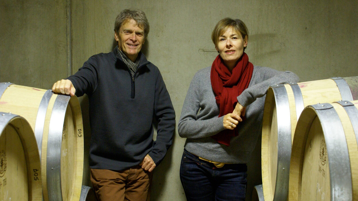 Hegarty with his wife and co-founder Philippa Crane leaning on a wine barrel