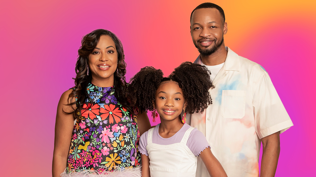 The Hollingsworth family in front of a pink and orange gradient background.